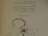 an open book with a drawing of a cat on it ' s cover