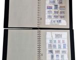 an open notebook with stamps and a pen on top of it