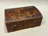 an old wooden box sitting on top of a white surface