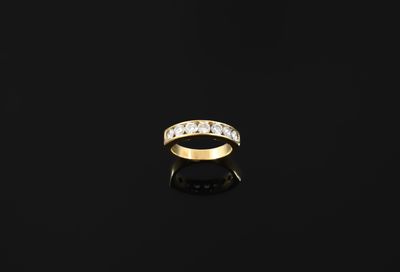 an 18k gold ring set with five round brilliant cut diamonds