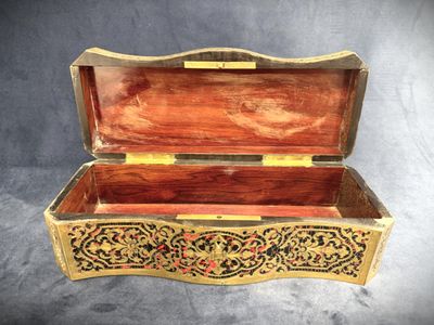 an old wooden box with a decorative design on the inside