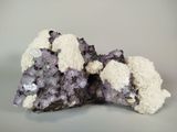 purple and white crystals on a gray surface