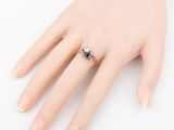 a close up of a person ' s hand with a ring on it