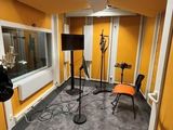 a room with two microphones and two chairs in it