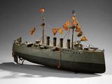 a small model of a boat with flags on it