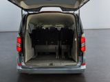 the back of a silver van with its doors open on the floor