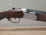 a close up of a rifle on a table with a wall in the background