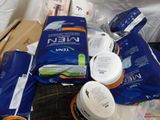 a pile of toilet paper, toilet paper, and other items on a bed