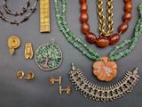 many different necklaces and bracelets that are on a table