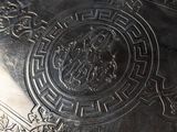 a silver tray that has a design on it