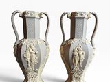two vases that are sitting side by side on a white surface