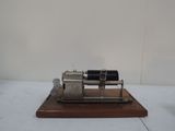 a small model of a small engine on a wooden stand