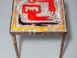 an image of a small table with a painting on top of it