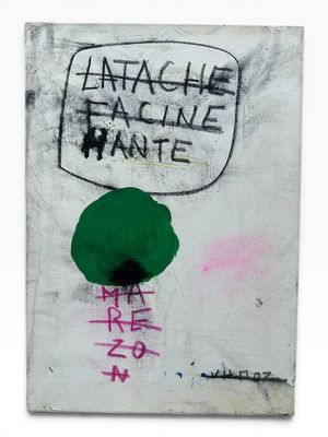 graffiti on a white wall with a green hat on top of it