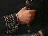 a painting of a man in a military uniform with a chain around his wrist