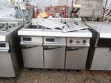 several stainless steel appliances are lined up outside in a warehouse