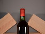 a bottle of wine sitting on a table next to wooden blocks