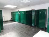 several green lockers are lined up in a row in a room