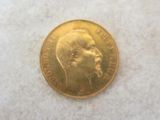 a close up of a gold coin with a man ' s face on it