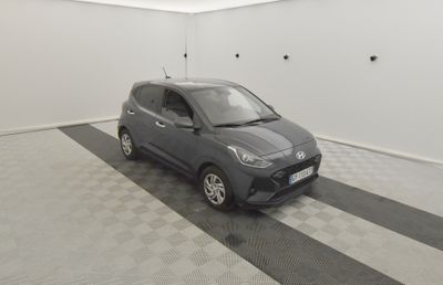 the small car is parked in the garage on the checkered floor