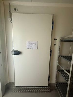 an image of a refrigerator in a small room
