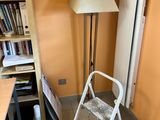 a chair and a lamp in the corner of a room
