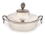 an antique silver plated casserole with a lid and handles