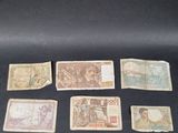 several different types of currency are displayed on a black surface