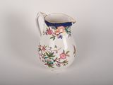 a white pitcher with a floral design on it