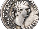 a silver coin with an image of a woman on it