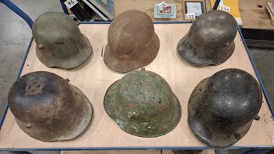 several helmets are sitting on top of a table in a warehouse