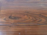 a close up of a wooden table with a clock on it