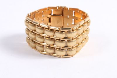 bracelet made of gold - plated metal on a white background