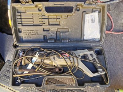 a tool in the case that is sitting on the floor