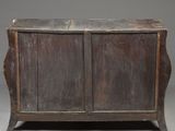 an old wooden chest with two doors and a drawer underneath it