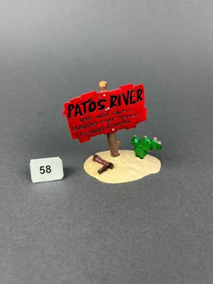 a small sign that says patto ' s diner next to a toy cactus