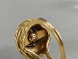 a gold ring with a flower inside of it