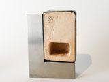 a small metal object with a small hole in it