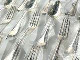 many forks and spoons that are wrapped in plastic