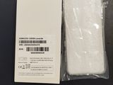 packaging of a white cell phone sitting on top of a black table