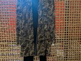black and white animal print jacket and leggings hanging on a wicker wall