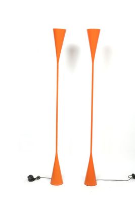 pair of orange floor lamps on a white background with a black cord