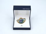 a close up of a blue and white broochle in a box