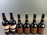 several bottles of wine are lined up in a row on a table