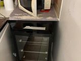 a microwave oven sitting on top of a counter in a small kitchen
