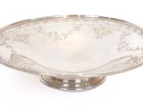 a silver plate on a stand on a white background