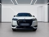 the front view of a white car in a white room