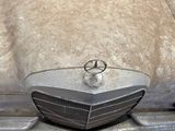 a close up of a car ' s front grill and badge