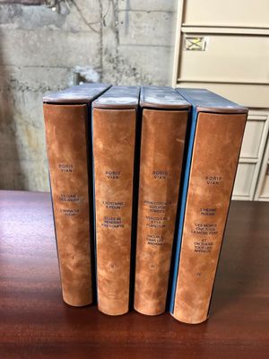 three books sitting on top of a wooden table next to each other