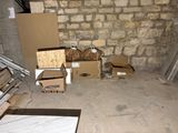 many boxes and boxes in a room with a brick wall